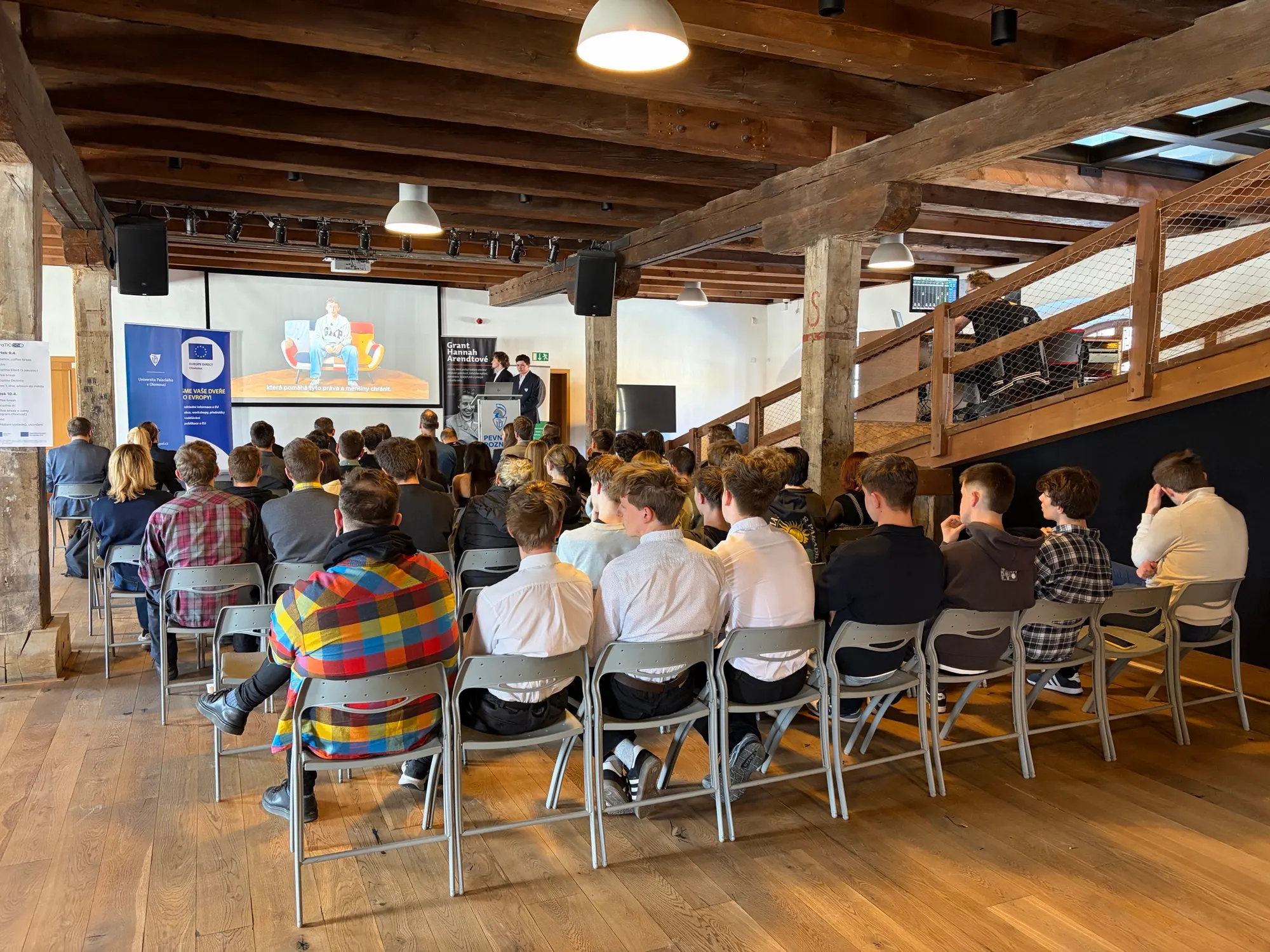 Audience watching a presentation in the final venue
