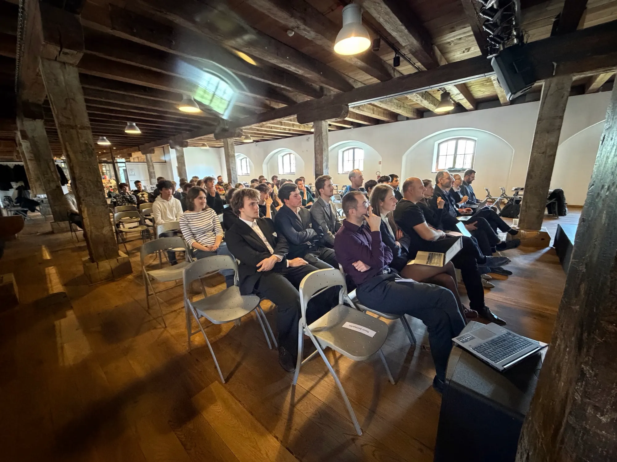 Participants seated beside the presentation stage