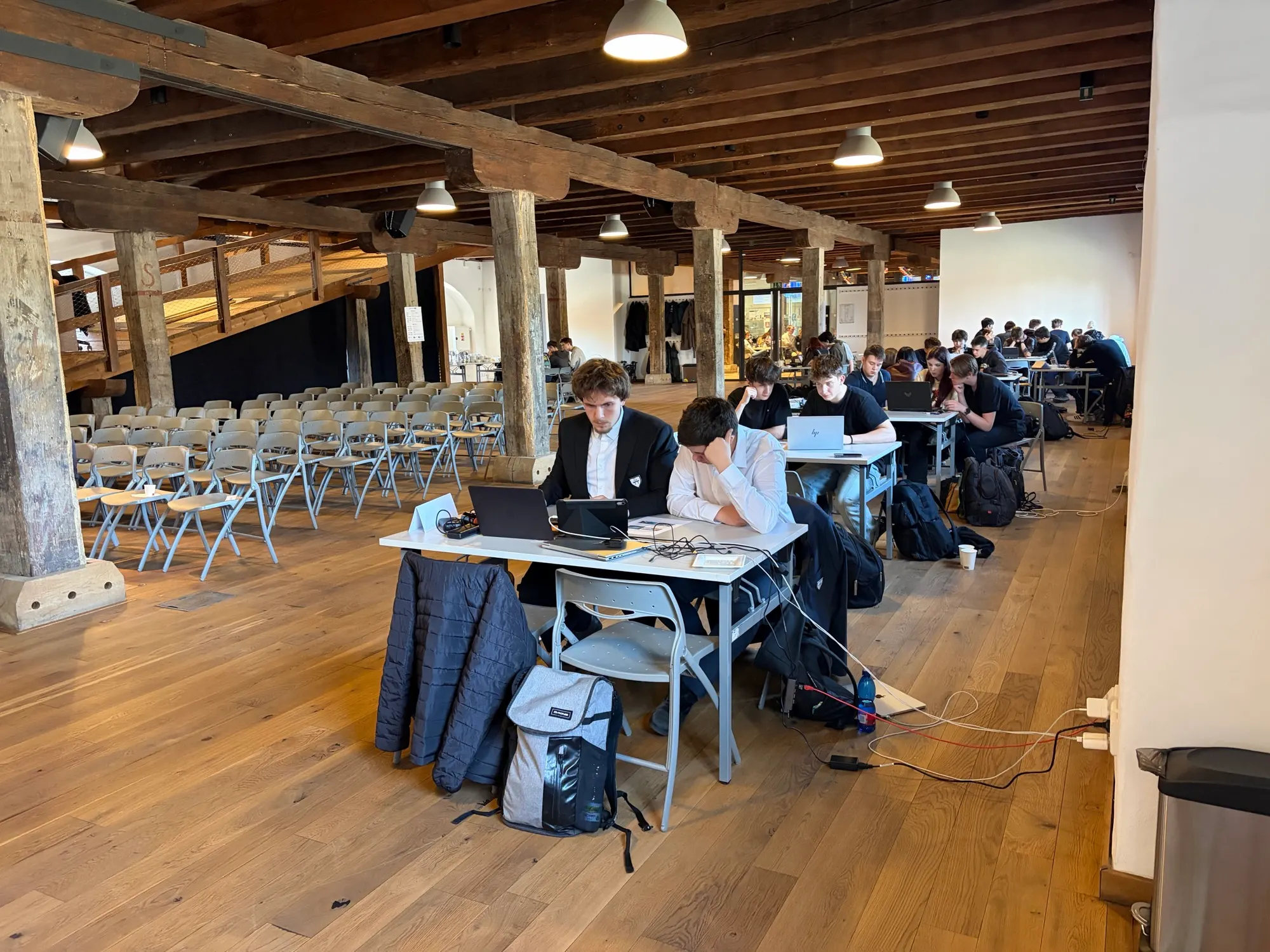 Students working at tables with laptops